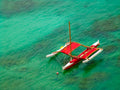 Red Sailboat on Turquoise Waters