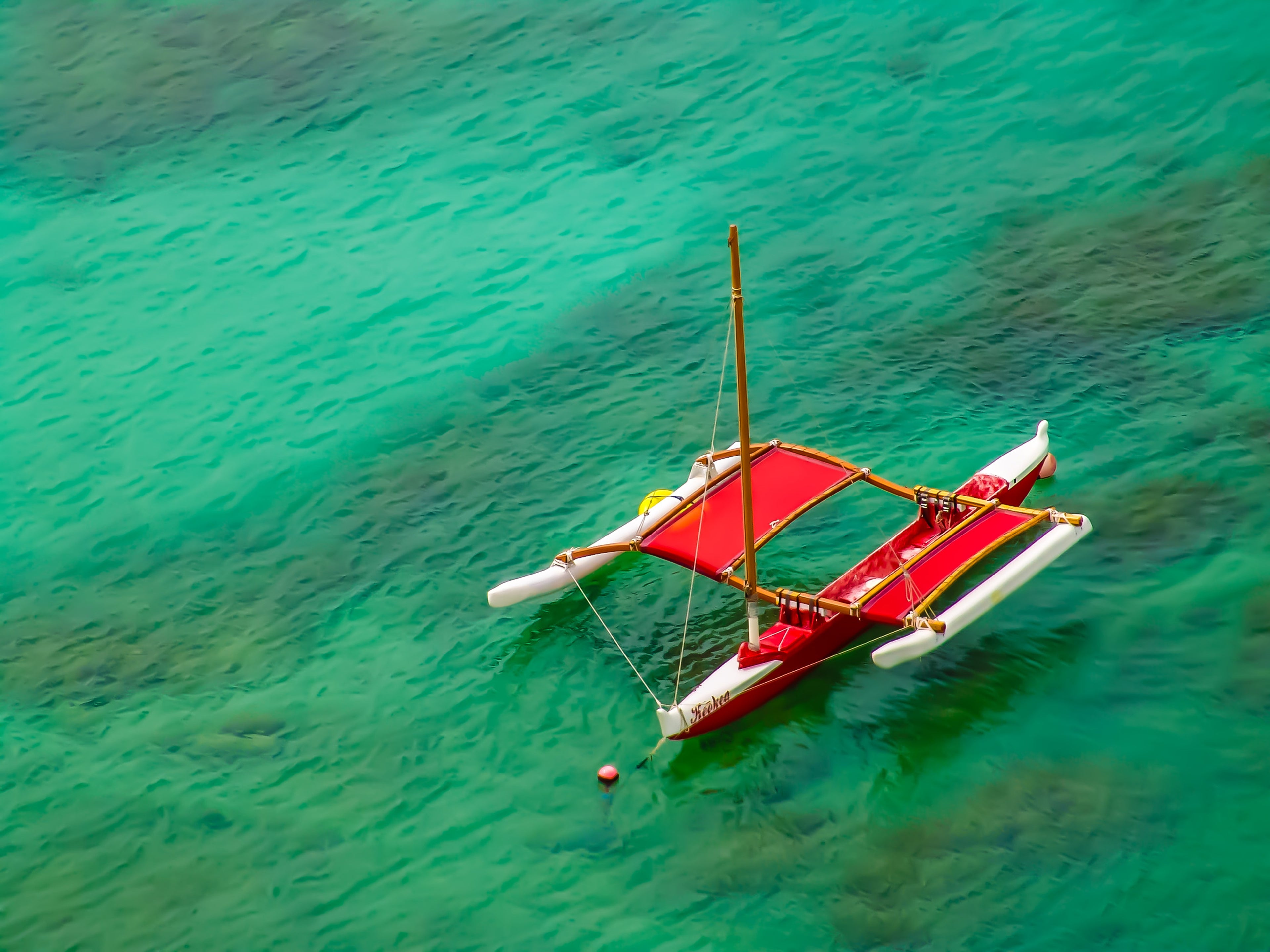 Red Sailboat on Turquoise Waters